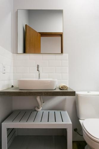 a bathroom with a sink and a toilet at Pousada Caminho Nômade in Praia do Rosa