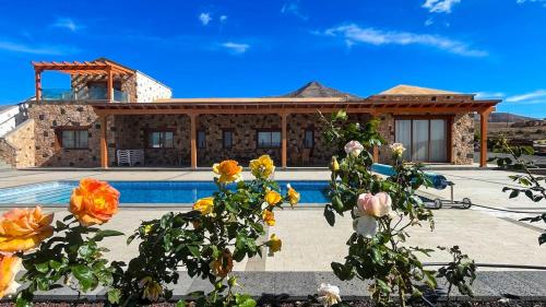 a house with a swimming pool in front of it at Yellow Room - Sunlite Double Private Room in Villa Barbuja in Tefía
