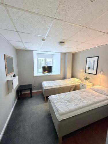 a hotel room with two beds and a tv at CentRum turistlogi in Borås