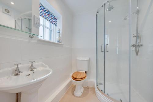 a bathroom with a toilet and a sink and a shower at 2 Bed in Southwold oc-twi2 in Southwold