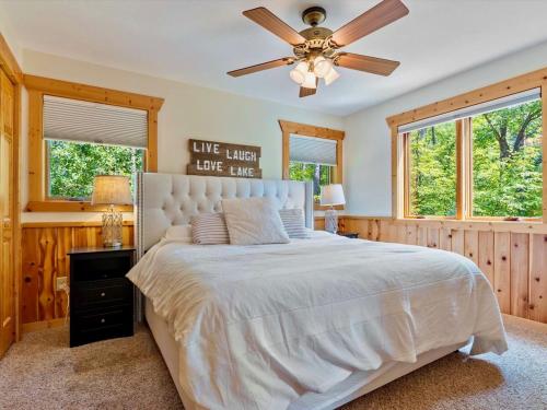 a bedroom with a large bed with a ceiling fan at Sunset Serenity on Kego Lake in Fifty Lakes