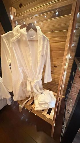 a white shirt on a hanger in a closet at Fabulosas da Serra in Monte das Gameleiras