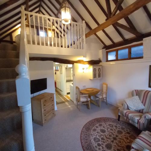a living room with a loft bed and a table at The Abbey Hotel & Apartments in Bury Saint Edmunds