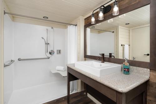 a bathroom with a sink and a mirror at Sun Outdoors Rocky Mountains in Granby
