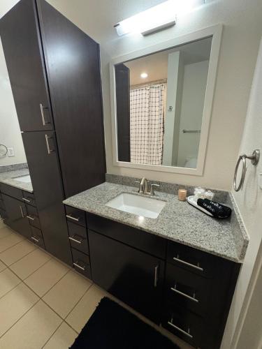 a bathroom with a sink and a mirror at The Residences At La Cantera in San Antonio