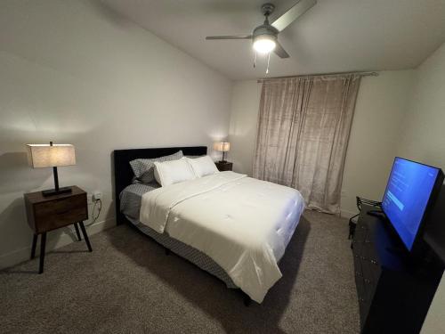 a bedroom with a bed and a flat screen tv at The Residences At La Cantera in San Antonio