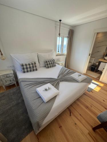 a bedroom with a large bed with two towels on it at Retiro Vale do Douro in Vila Marim
