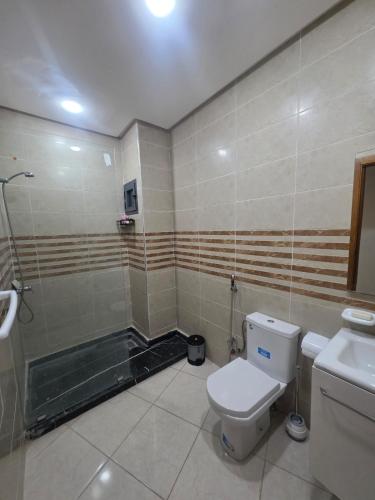 a bathroom with a toilet and a shower at Massira Green Park Serenity in Kenitra