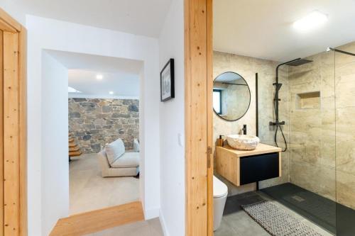 a bathroom with a toilet and a sink and a mirror at Golden View in Vale de Tábuas