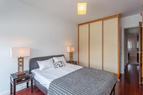 a bedroom with a bed and a glass door at Lisbon at Home in Lisbon