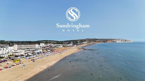 a view of a beach with people in the water at Sandringham Hotel - Seafront, Sandown, Isle of Wight - FREE Return Car Ferry for 3 nights or more in Sandown