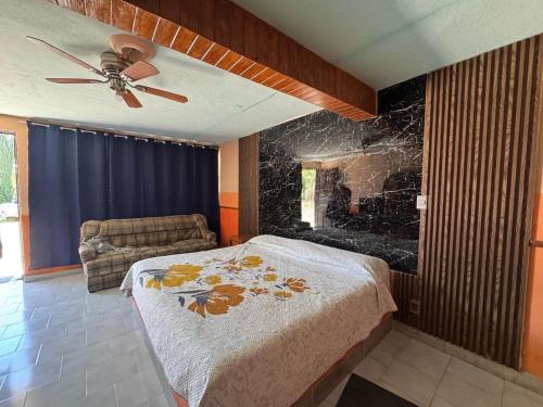 a bedroom with a bed and a fireplace at Hotel Acambay in Acambay