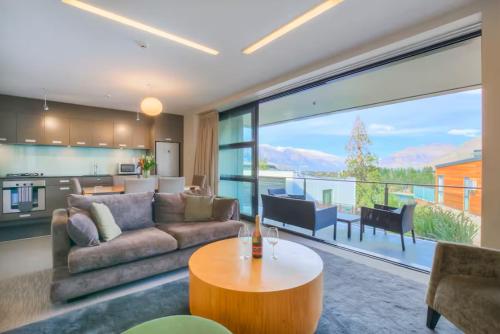 a living room with a couch and a table at Panorama Terrace Apartments - Element Escapes in Queenstown