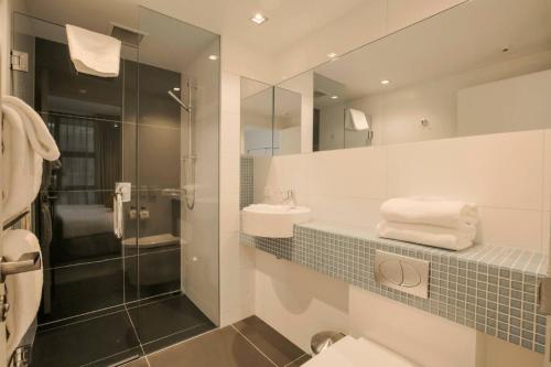 a bathroom with a toilet and a sink and a shower at Panorama Terrace Apartments - Element Escapes in Queenstown
