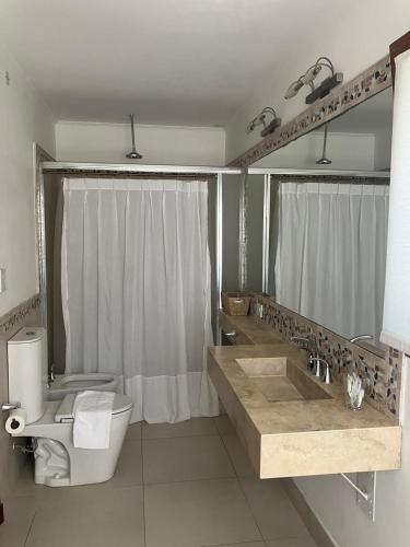 a bathroom with a sink and a toilet and a shower at Casa Clara in Rufino