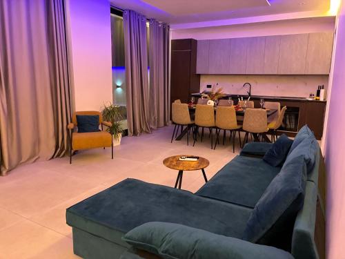 a living room with a blue couch and a table at Mia Villa in Draç