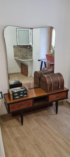a room with a couch and a table with a mirror at Nonno Ludovico in Roccasicura