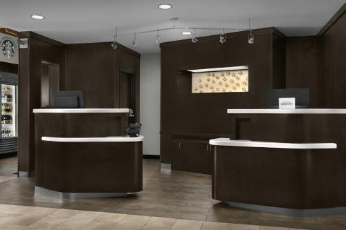 a lobby with two counters and a window at Courtyard Greensboro Airport in Greensboro