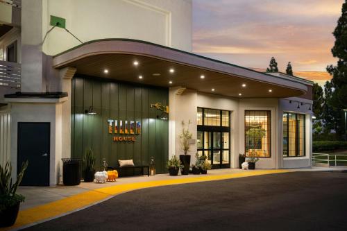 a store front of a building with a yellow curb at Tiller House, Laguna Hills, a Tribute Portfolio Hotel in Laguna Hills