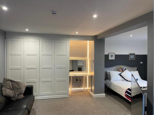 a bedroom with a bed and a couch and a desk at Apartment B in Bangor