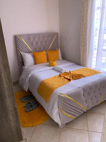 a bedroom with a large bed with shoes on the floor at Nanako Comforts in Kitengela 