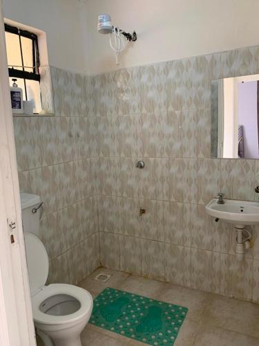 a bathroom with a toilet and a sink at Nanako Comforts in Kitengela 