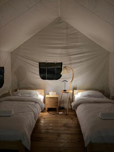 a room with two beds in a tent at Nawesa Resort in Eton