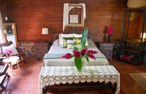 a bedroom with a bed with flowers on it at The Hummingbird house, Costa Rica in Atenas
