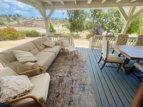a living room with a couch and a table at Amazing Ranch Home in Temecula wine country in Temecula