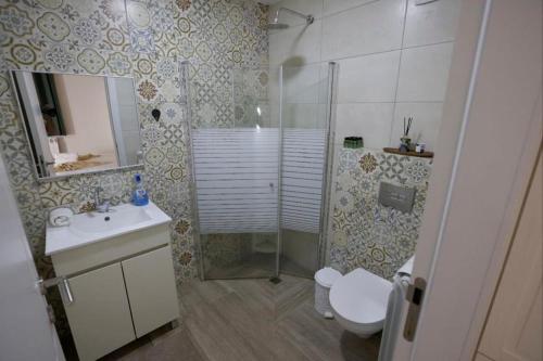 a bathroom with a shower and a toilet and a sink at להנות מהטבע שמס in Majdal Shams