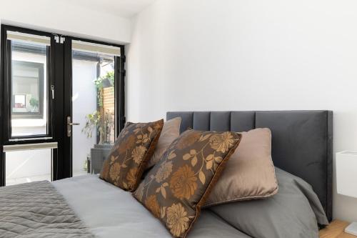 a bed with two pillows on top of it at Howth Village Cottage in Howth