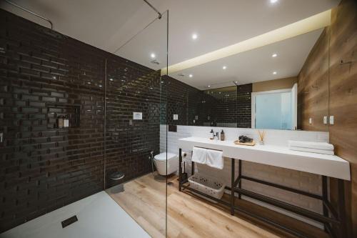 a bathroom with a sink and a toilet at CONDE13 Aparthotel Boutique in Lisbon