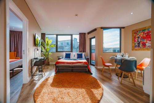a bedroom with a bed and a table and chairs at CONDE13 Aparthotel Boutique in Lisbon