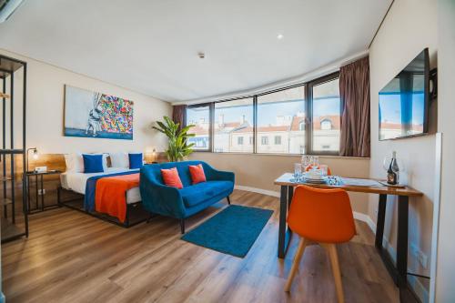 a hotel room with a bed and a desk and a couch at CONDE13 Aparthotel Boutique in Lisbon