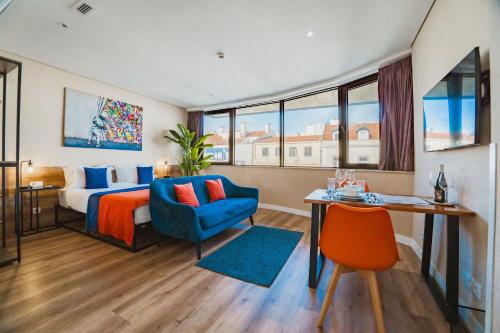 a hotel room with a bed and a desk and a chair at CONDE13 Aparthotel Boutique in Lisbon