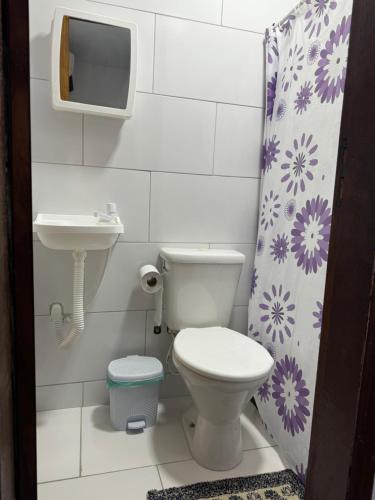 a bathroom with a toilet and a sink at El Laai Roi in Iguaba Grande