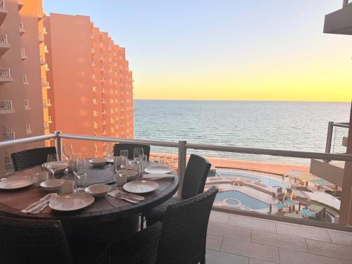 a table on a balcony with a view of the ocean at Las Palomas OV 4BR 4BA Cortez 901 in Puerto Peñasco