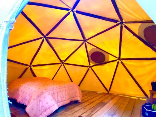 a room with a bed inside of a yurt at Cabanas Madre Tierra Zacatlan in Cedro