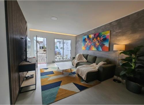 a living room with a couch and a table at Vista Mar in Ponta Delgada