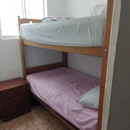 a bunk bed in a small room with a mattress at La Palmera Apartment in San Bartolo