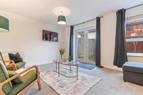 a living room with a couch and a table at Spacious 4-Bed Home Near Cribbs & Bristol in Bristol