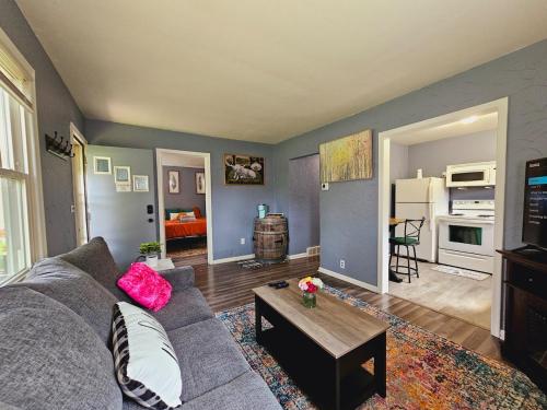 a living room with a couch and a table at Stay St Paul Haven in West Saint Paul