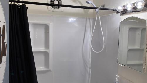 a shower in a bathroom with a black shower curtain at Stay St Paul Haven in West Saint Paul