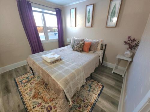 a small bedroom with a bed with a window at Stay St Paul Haven in West Saint Paul