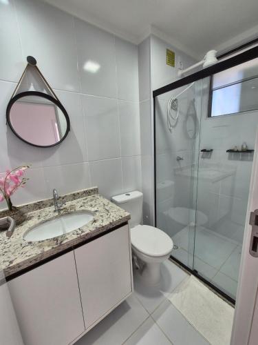 a bathroom with a toilet and a sink and a shower at Beira Mar Apartment Aracaju in Aracaju