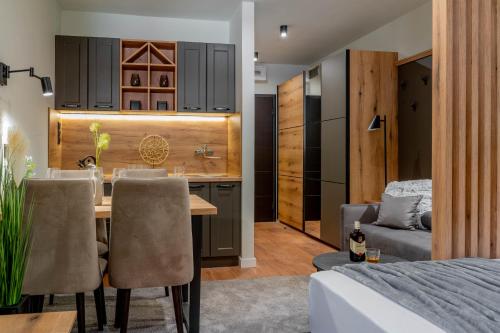 a kitchen and living room with a table and chairs at Apart-Hotel Bela Reka in Brzeće