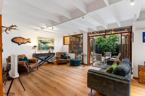 a living room with a couch and a piano at Napier St in Auckland