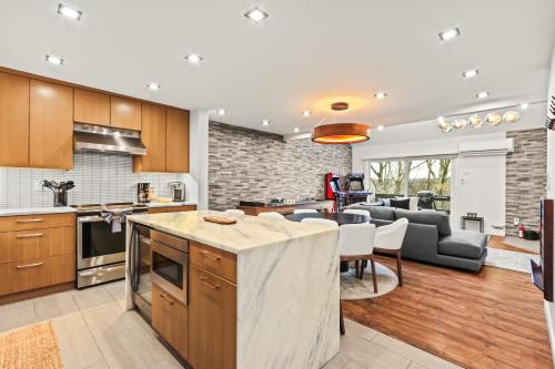 an open kitchen and living room with a couch at Home at Camelback Mtn with Game Room near Waterparks in Tannersville