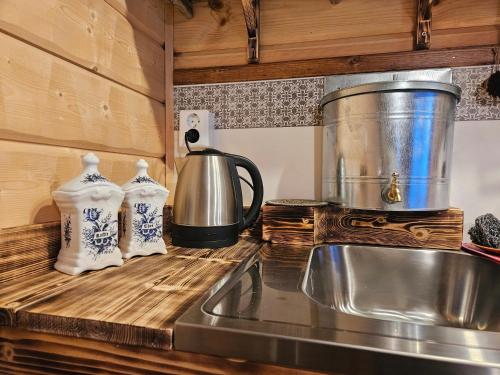 a kitchen counter with a sink and a coffee pot at The Lakeview Cabin in Kiruna
