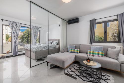 a living room with a couch and a bed at NOVA SPA - Sauna Suite for Two in Rijeka